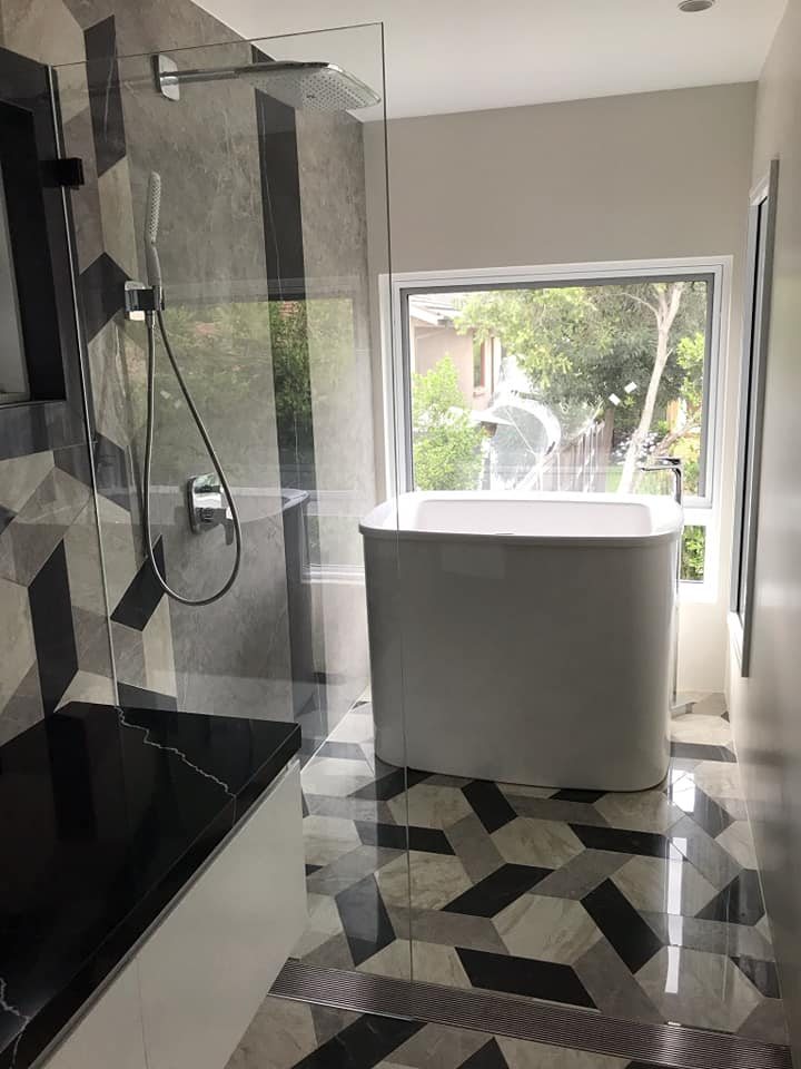 AQVA Haiku Solo 1300 freestanding bath in front of a window